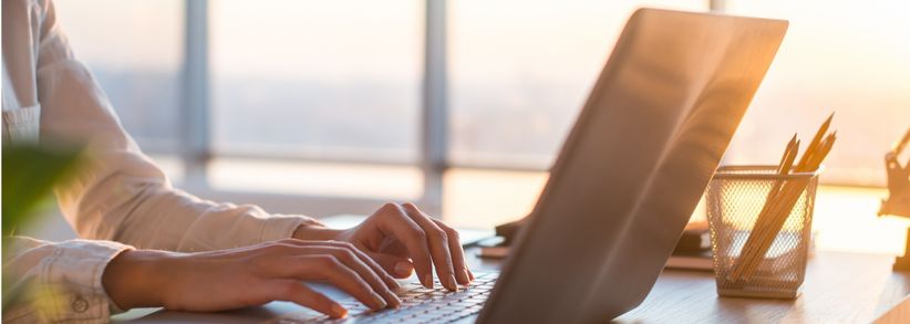 Industry content writer's hands typing on a computer